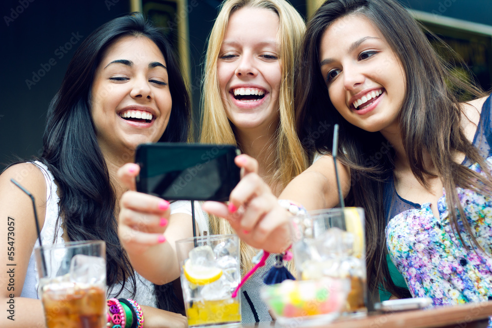 three friends taking photos with a smartphone three friends taking photos with a smartphone