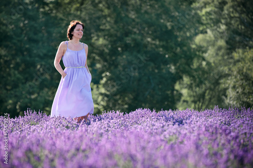 Beautiful woman relaxing in lavender field