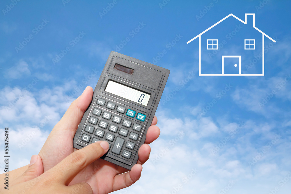 Calculator in Hand on blue sky Calculator in Hand on blue sky