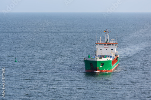 Aerial view of a freighter sailing at the big blue sea