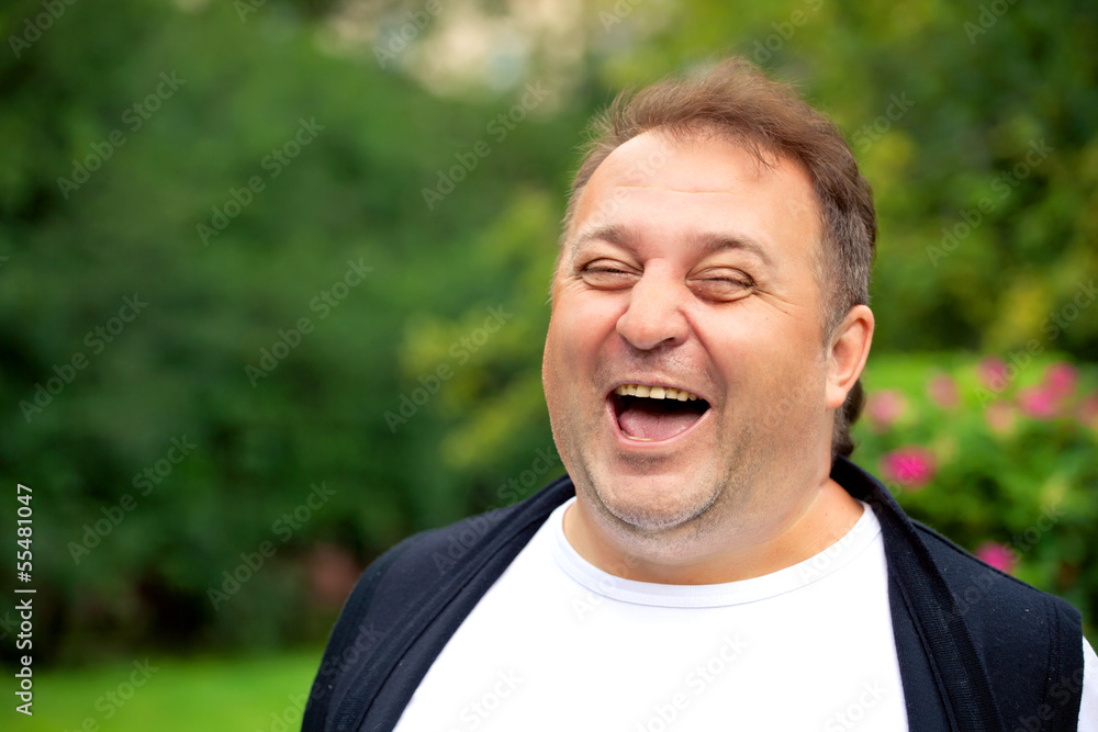 Handsome overweight man smiling and relaxing outdoor Handsome overweight man smiling and relaxing outdoor