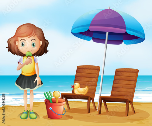 A girl eating an icecream at the beach