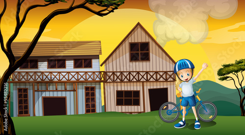 A female biker in front of the two wooden farmhouses