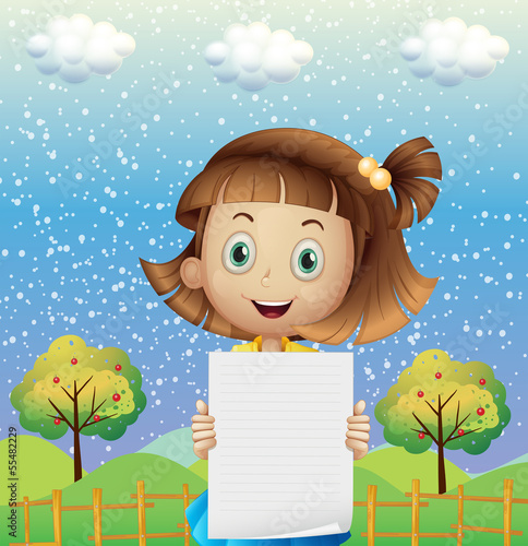 A small girl holding an empty paper near the fence