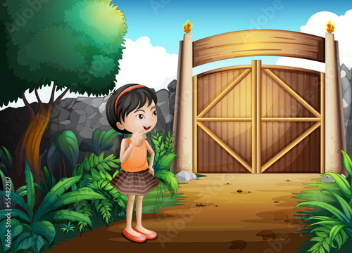 A gated yard with a young girl