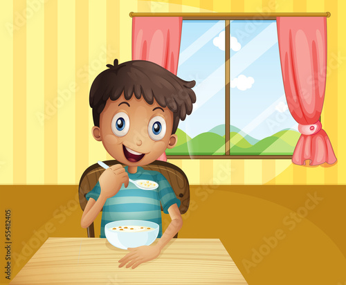 A boy eating cereals inside the house