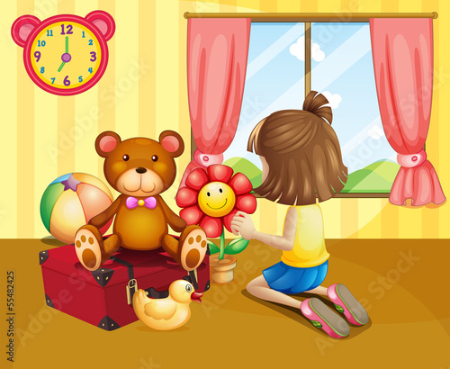 A child arranging her toys inside the house