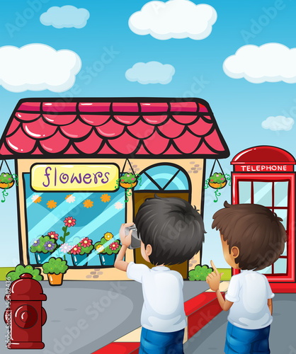 Two boys taking photos near the flower shop