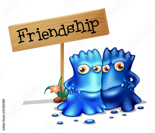 Two blue monsters beside a signage