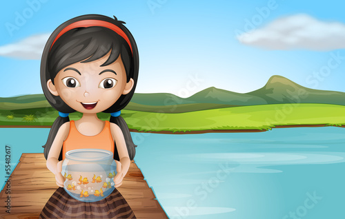 A girl with an aquarium standing at the diving board