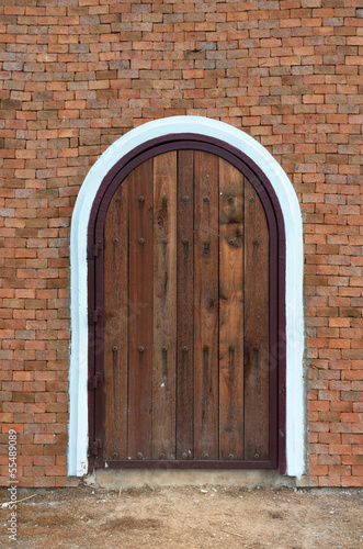 arch wooden door with brick building