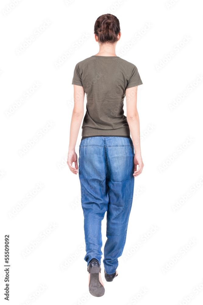 back view of walking woman in jeans . back view of walking woman in jeans .