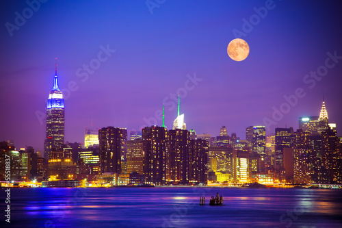 New York City skyline at night under a full moon