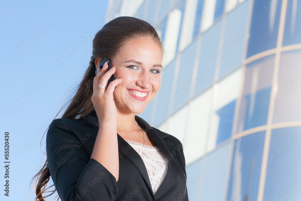 Beautiful businesswoman talking with mobile phone Beautiful businesswoman talking with mobile phone