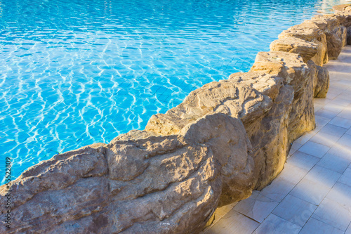 side of pool is edged with stone