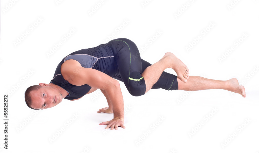 Маn doing Yoga exercises. Challenge Pose - Koundiyanasana Маn doing Yoga exercises. Challenge Pose - Koundiyanasana