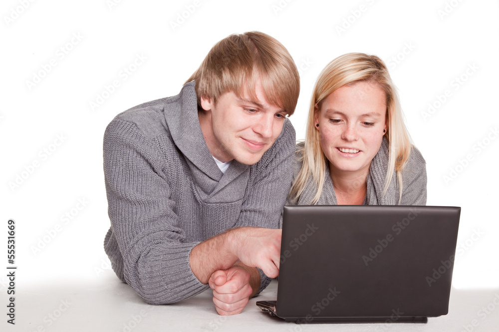 couple shopping together with a laptop