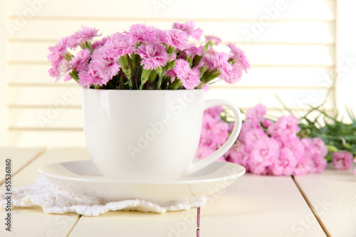 Wallpaper Mural Many small pink cloves in cup on wooden background Torontodigital.ca