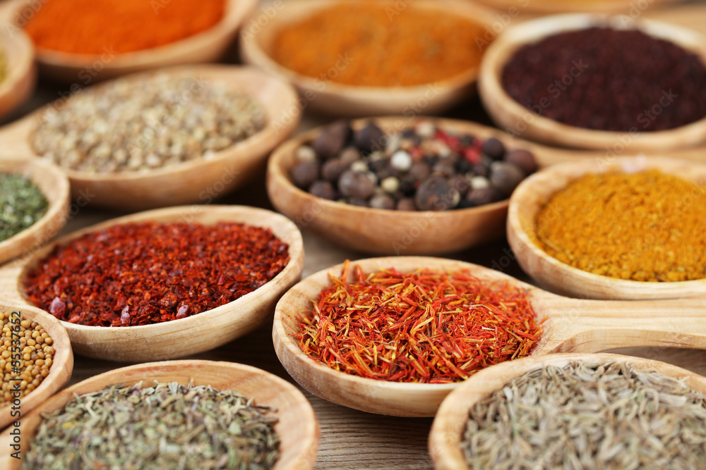 Assortment of spices in wooden spoons close-up