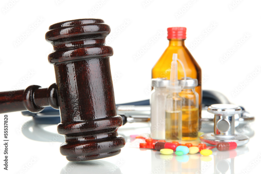 Medicine law concept. Gavel and pills isolated on white Medicine law concept. Gavel and pills isolated on white