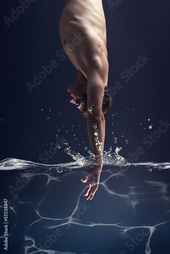 swimmer jumps into the water.