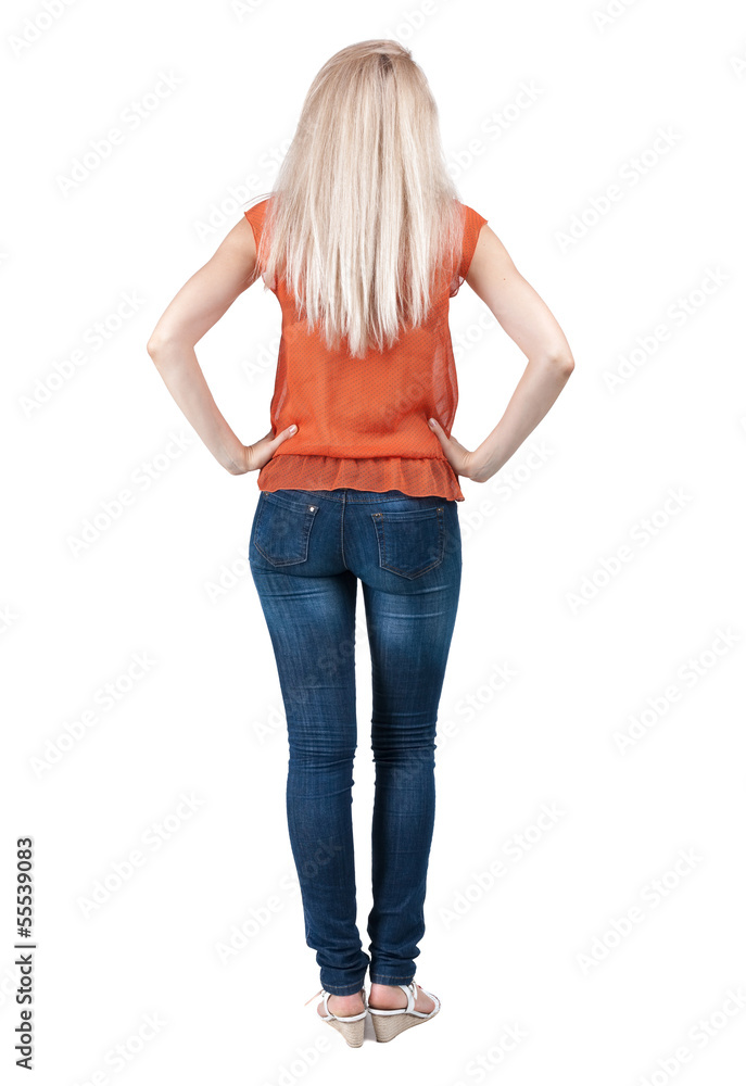 Obraz premium back view of standing young beautiful blonde woman.