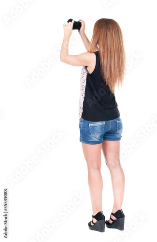 Back view of woman photographing.