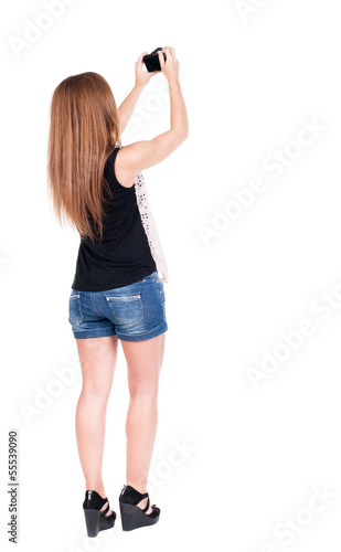 Back view of woman photographing.