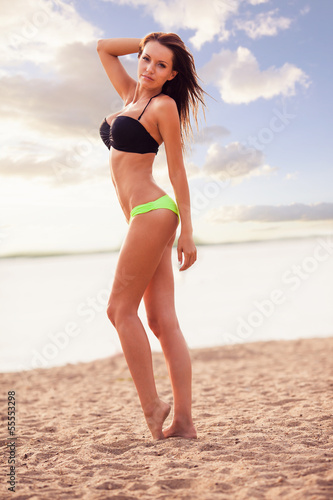 woman wearing bikini walking on beach