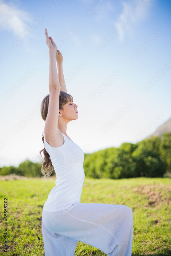 Peaceful young woman stretching outside Peaceful young woman stretching outside