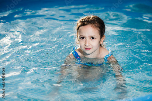 Girl swims in the pool