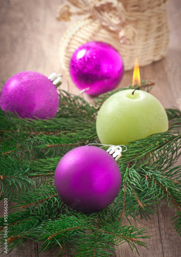 Christmas card with Christmas balls and a burning candle