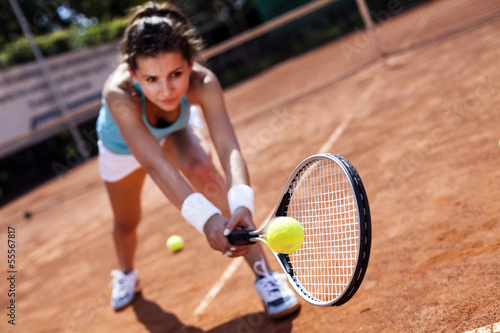 Beautiful girl smiling with a tennis racket © BrunoWeltmann