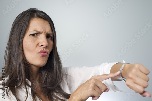 woman tapping on wrist watch