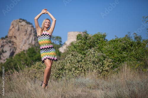 Beautiful young blond woman wearing bright dress