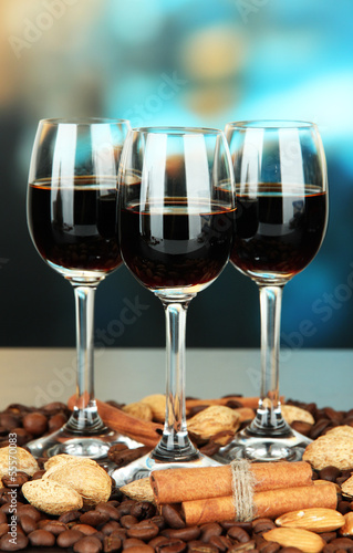 Glasses of liquors with almonds and coffee grains,