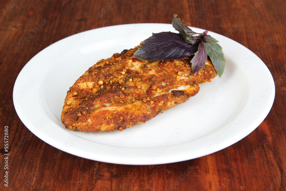 Roasted chicken fillets on white plate, on wooden background Roasted chicken fillets on white plate, on wooden background