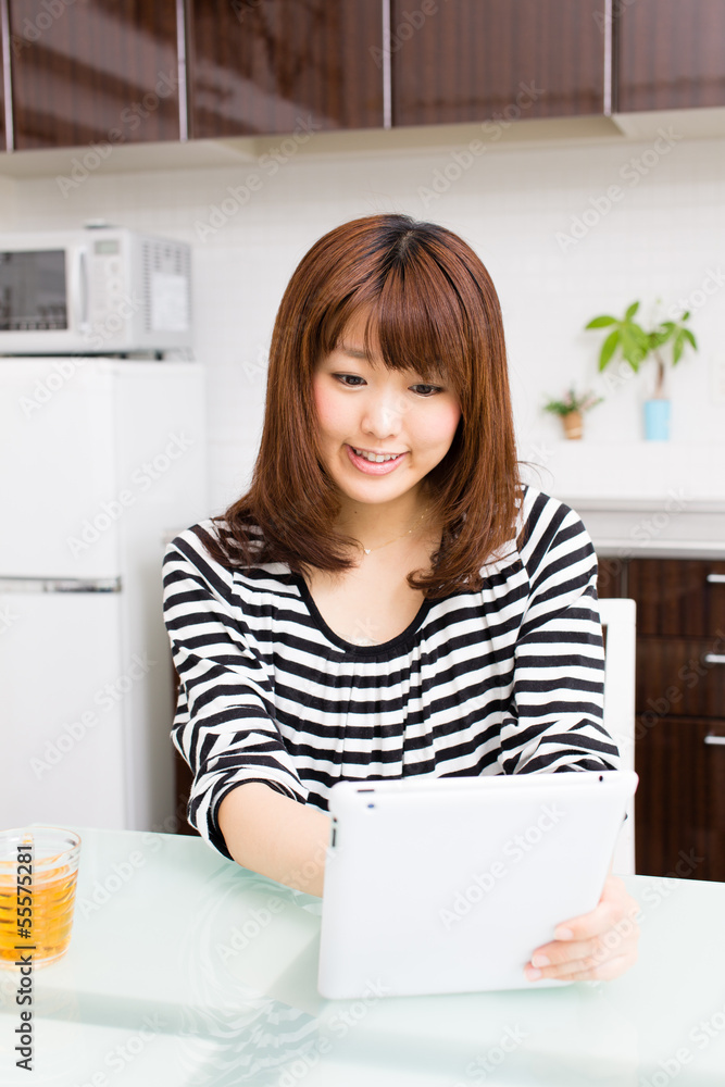 young asian woman relaxing in the kitchen young asian woman relaxing in the kitchen