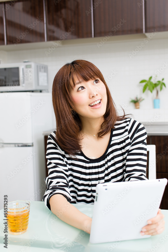 young asian woman relaxing in the kitchen young asian woman relaxing in the kitchen