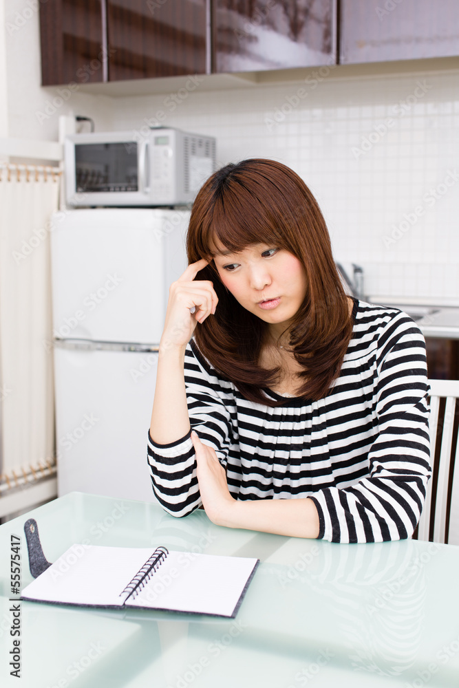 young asian woman relaxing in the kitchen young asian woman relaxing in the kitchen