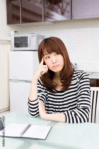 young asian woman relaxing in the kitchen