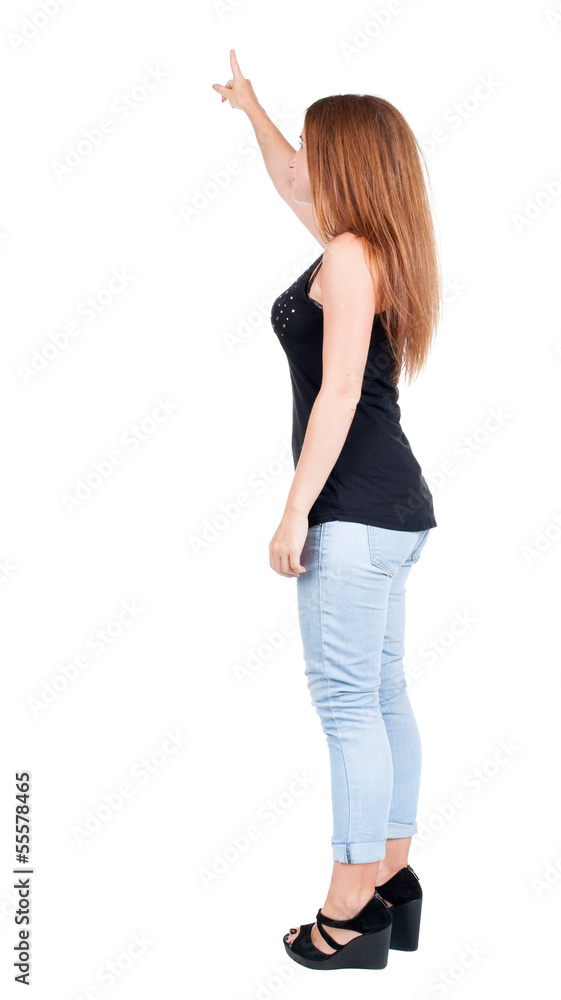 Back view of pointing woman. redhead girl teaches. Back view of pointing woman. redhead girl teaches.