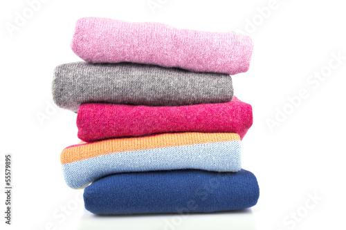 A stack of colored, woolen jumpers