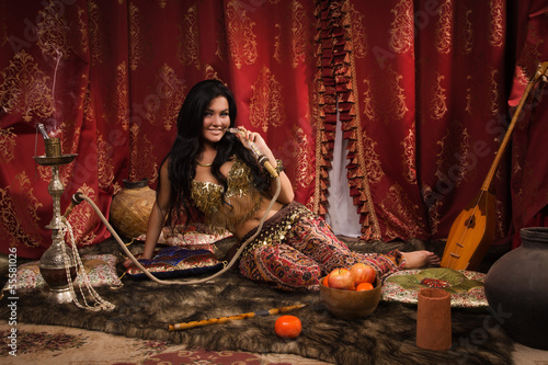 Beautiful arabic woman with hookah photo