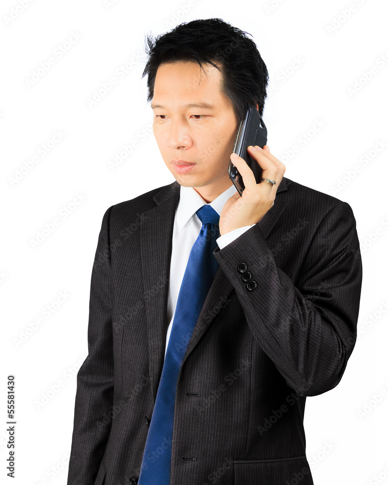 Asian business man makes a phone call over white Asian business man makes a phone call over white