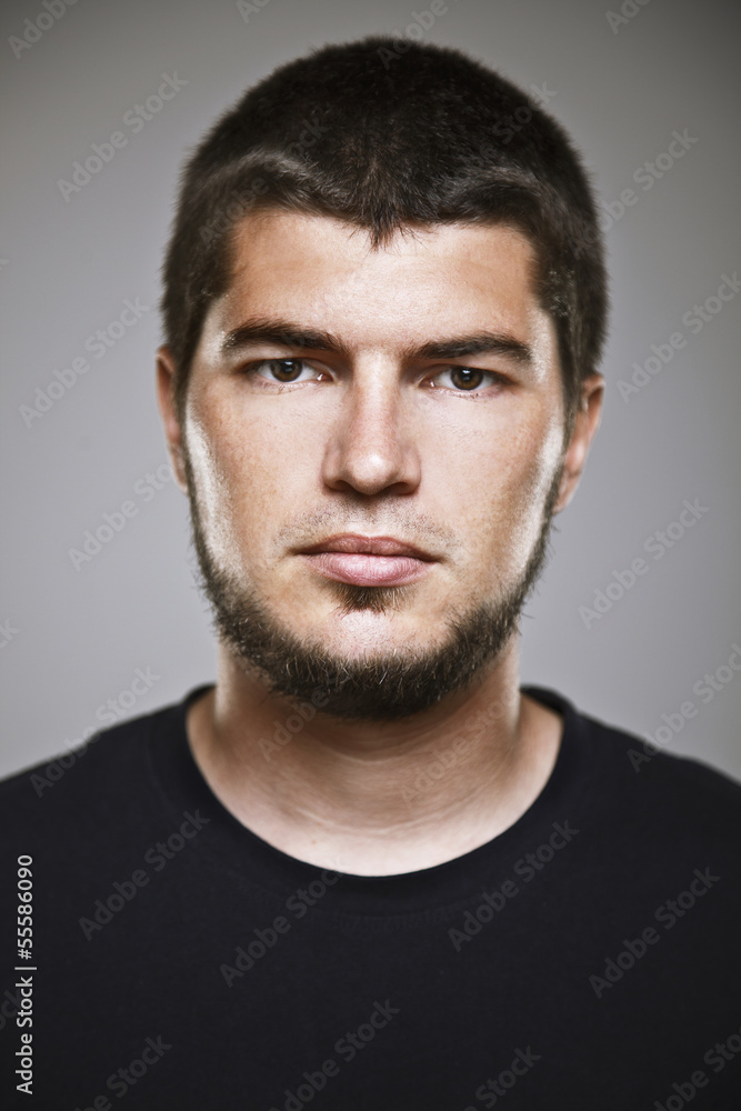 Portrait of a real smiling man over grey background. Portrait of a real smiling man over grey background.