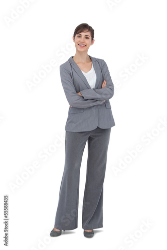 Cheerful businesswoman with arms crossed smiling at camera