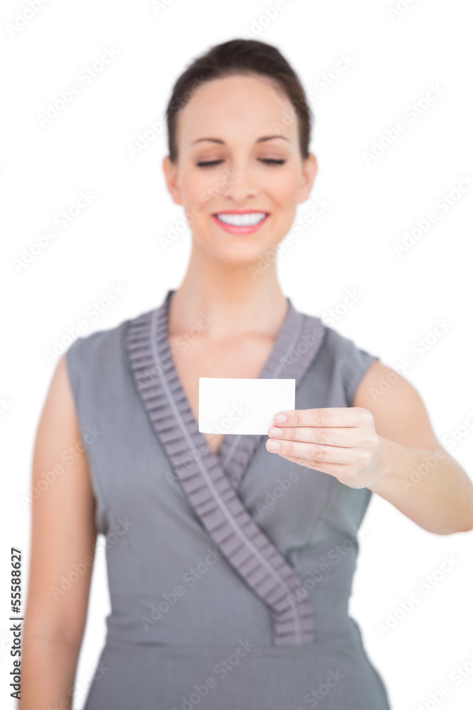 Smiling seductive model holding business card Smiling seductive model holding business card