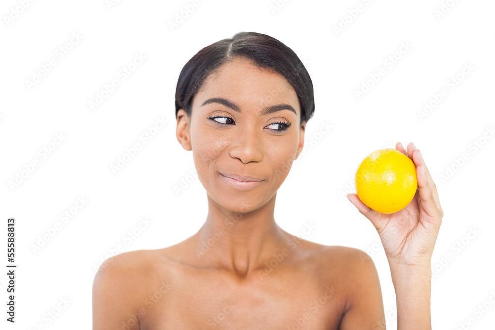 Cheerful attractive model holding orange Cheerful attractive model holding orange