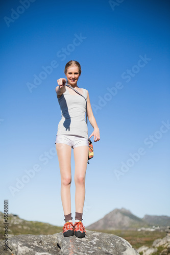 Smiling woman standing on rock